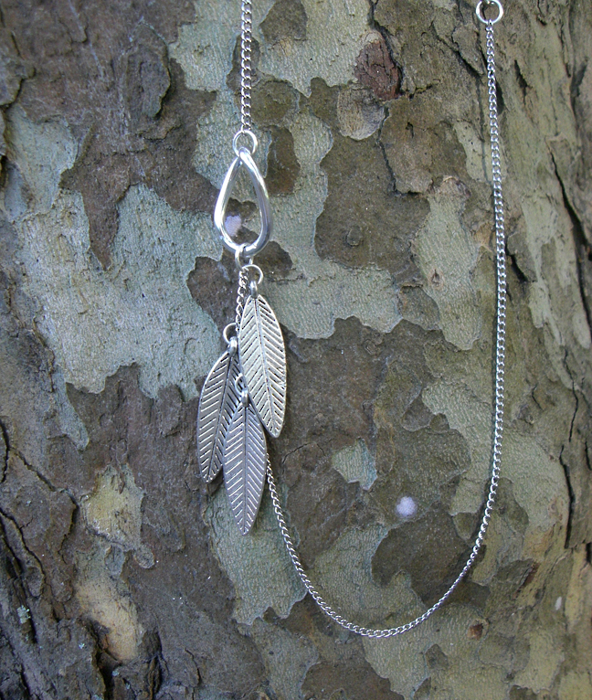 metal 3 feather pendant fashion accessory by Native American designer Tatakwan - detail